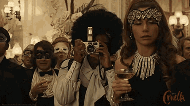 a woman is holding a glass of wine while taking a picture