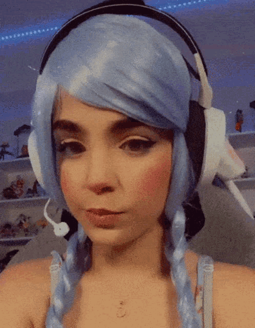 a girl wearing a blue wig and headphones