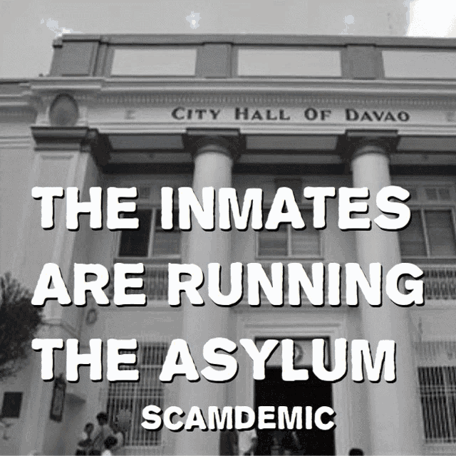 the inmates are running the asylum scamdemic written on a poster
