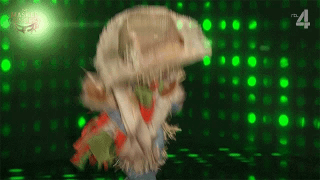 a person in a jellyfish costume is dancing in front of a green background with the number 41 on it