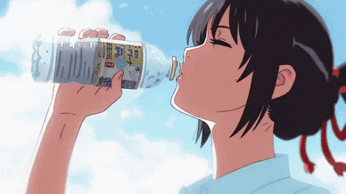 a girl drinking water from a bottle with chinese writing
