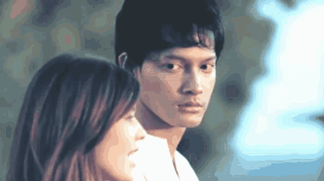 a man and a woman looking at each other