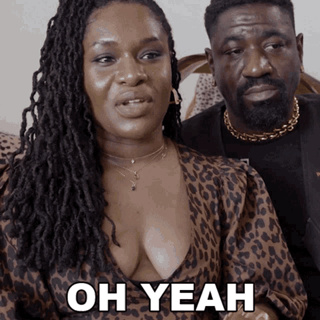 a woman in a leopard print dress says oh yeah in front of a man