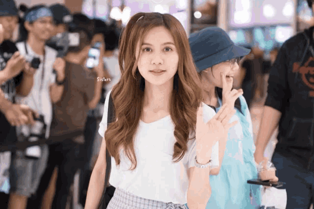 a girl in a white t-shirt with sisters written on it