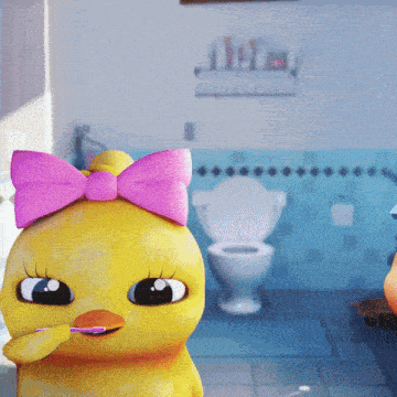 a yellow duck with a pink bow is brushing its teeth in a bathroom