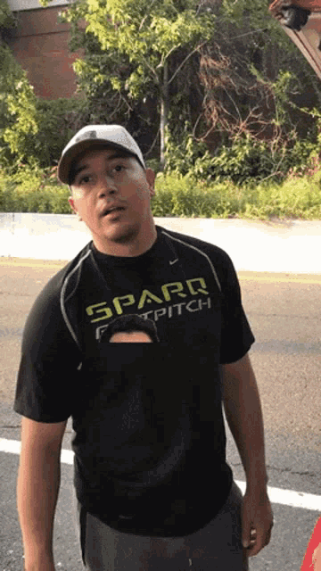 a man wearing a black shirt that says spard foot pitch