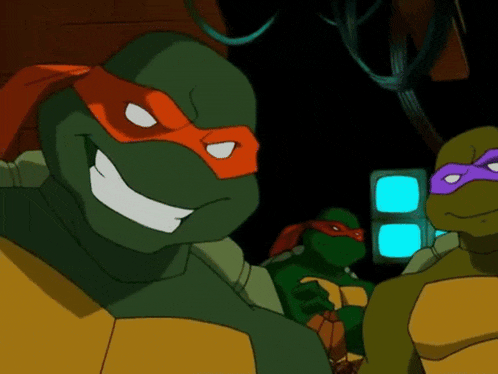 a group of teenage mutant ninja turtles are smiling