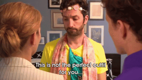 a man with a flower crown on his head says " this is not the perfect outfit for you .. "