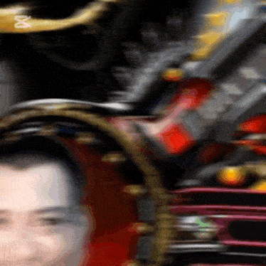 a blurry picture of a man 's face with an x on the bottom left