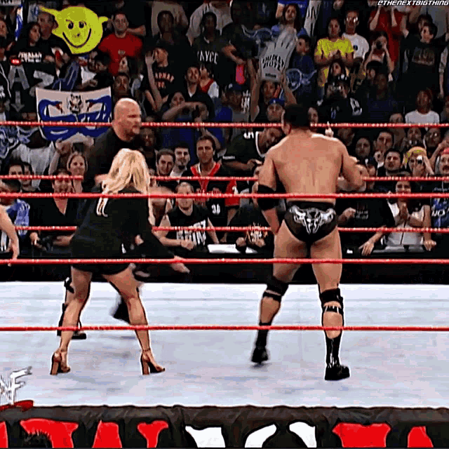 a man in a wrestling ring with a smiley face on the wall behind him