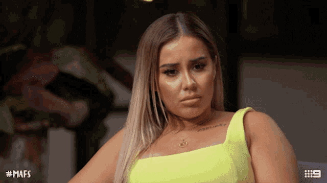 a woman in a neon yellow top has the hashtag # mafs on her shoulder