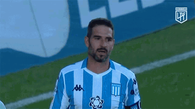 a man in a blue and white striped shirt with the word racing on the front