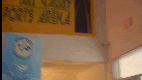 a blurred image of a room with a sign on the wall that says ' no one 's asha '