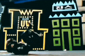 a person is laying on the ground in front of a sign that says club