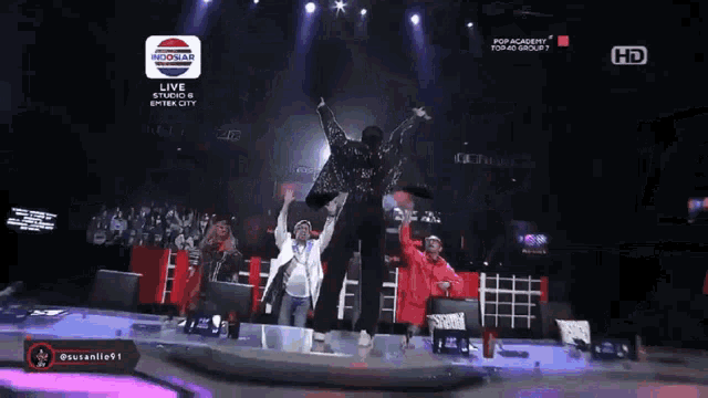 a group of people on a stage with a sign that says indomare