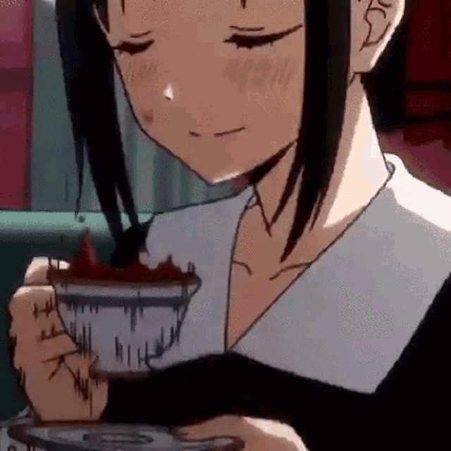 a girl is holding a cup of coffee with strawberries on it .