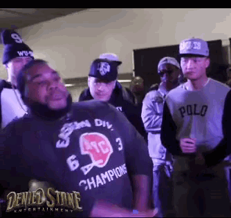 a man wearing a shirt that says champions is dancing in front of a crowd