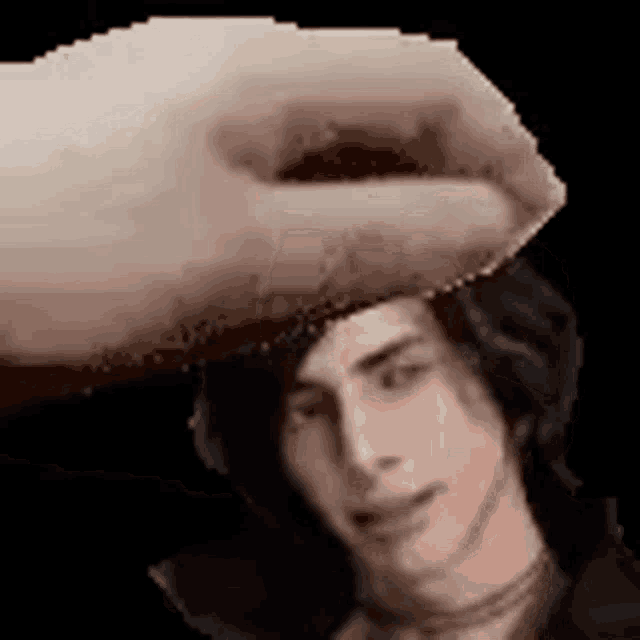 a hand is holding a piece of paper over a man 's head in a pixel art style .