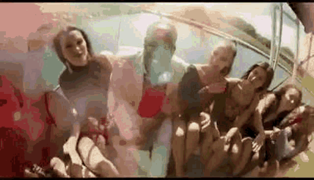 a group of people are sitting on a boat and looking at the camera .