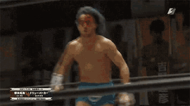 a wrestling match is being shown on a tv screen with a banner that says r on it