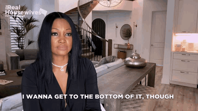 a woman says i wanna get to the bottom of it though in a living room