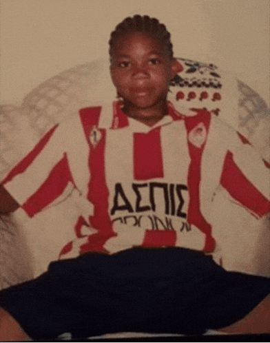 a young boy wearing a red and white striped shirt with the word aepie on the front