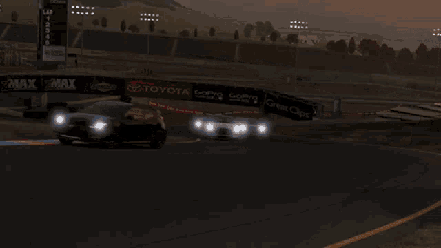 a red car is driving down a road next to a white one