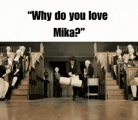 a group of people are sitting in a room with the words " why do you love mika " on the top