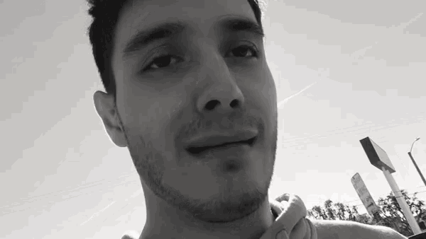 a man with a beard is smiling for the camera