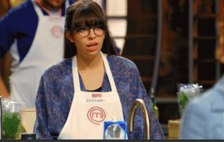 a woman wearing glasses and an apron that says bri on it