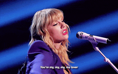 a woman singing into a microphone with the words " you 're my my my my lover "