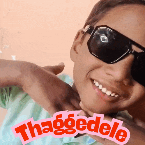 a young boy wearing sunglasses with the word thaggedele on the bottom right