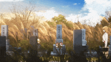 a woman stands in front of a cemetery with chinese writing on the gravestones