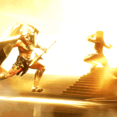 a man in a spartan costume is holding a spear and a woman is jumping on a set of stairs