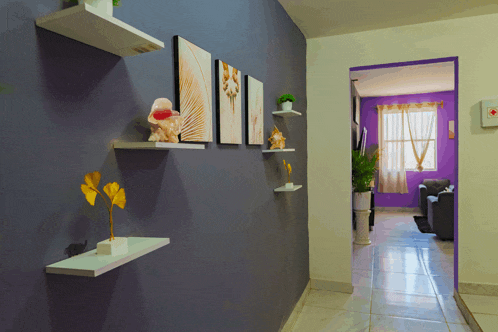 a hallway with a purple wall and white shelves with flowers on them