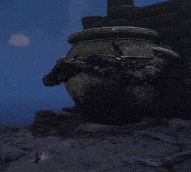 a statue of a monster is standing in front of a castle