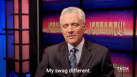 a man in a suit and tie says my swag different in front of a jeopardy screen