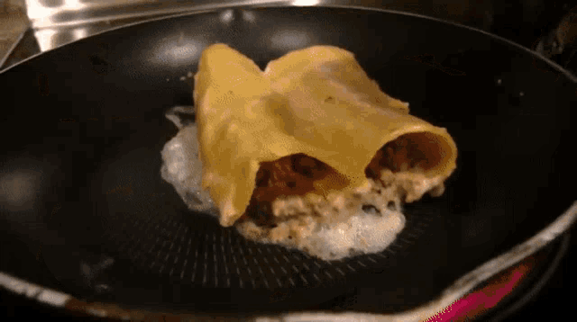 a piece of food is being cooked in a pan