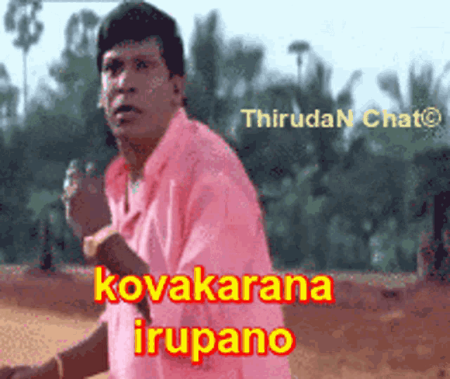 a man in a pink shirt with kovakarana irupano written in red