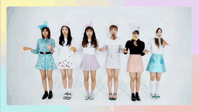 a group of girls standing next to each other wearing bunny hats and skirts