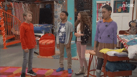 a group of kids standing in a room with a nick logo on the bottom