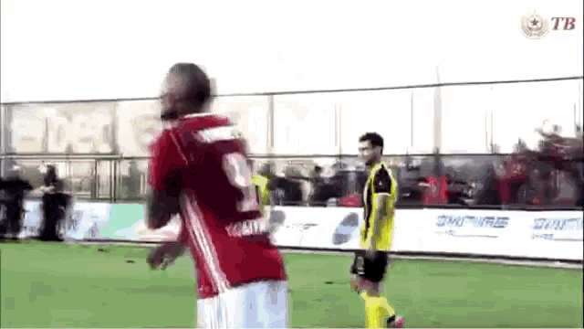 a soccer player in a red jersey with the number 9 on it