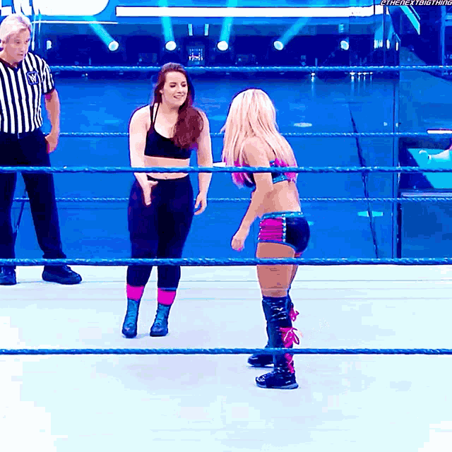 two women are standing in a wrestling ring with a referee in the background and the hashtag #thenextbig thing