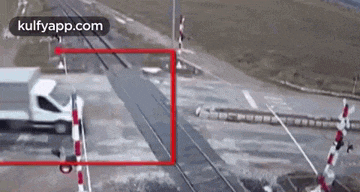 a truck is crossing a railroad crossing with a red border .