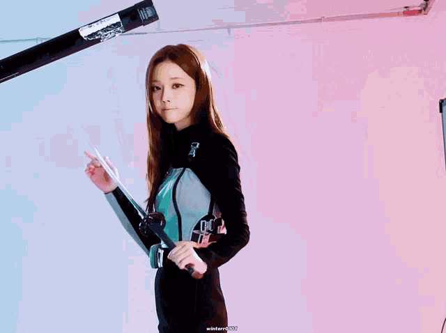 a woman holding a sword with the words winter2020 written below her