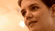a close up of a woman 's face with a blurred background and a light behind her .