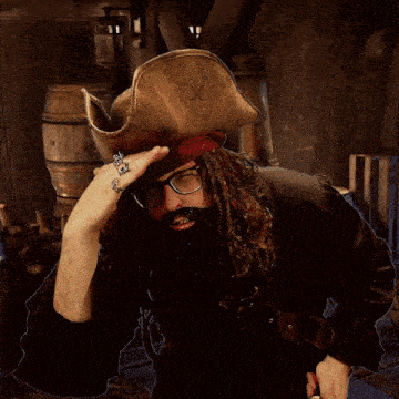 a man in a pirate costume with glasses and a beard
