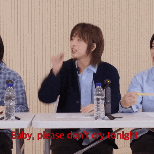 a group of people sitting at a table with the words baby please do n't cry tonight on the bottom