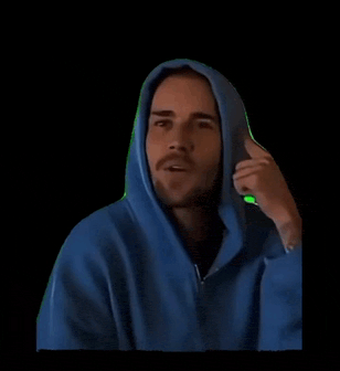 a man wearing a blue hoodie is talking on a phone .