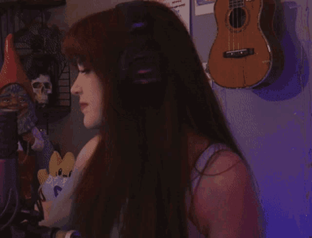 a girl wearing headphones giving a peace sign